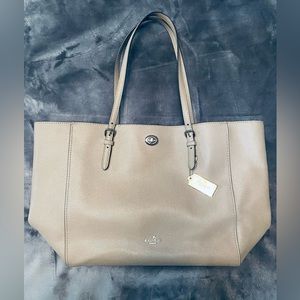 Coach tote bag with zip top.